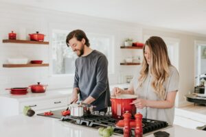 Couple cooking in the kitche, smiling