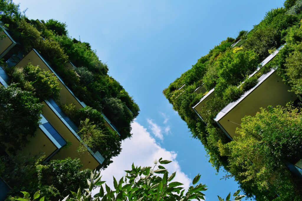 Eco-friendly buildings with bushes and greenery on the exterior.