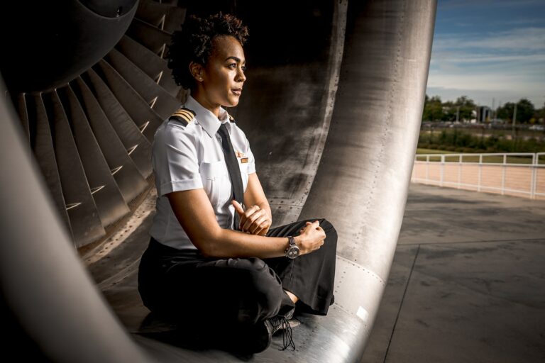 Ethnic lady pilot sitting cross-legged in an engine inlet