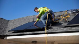 Engineer on roof installing solar panels