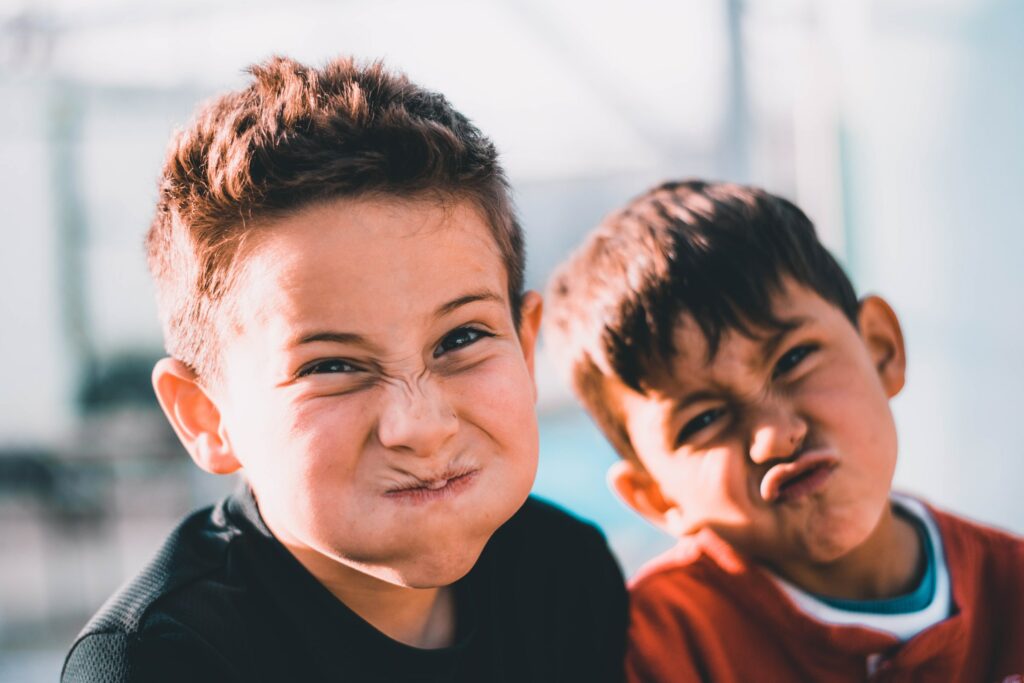 Two boys pulling faces at the camera.