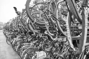 A row of bicycles parked at Amsterdam train station. B&W photo.