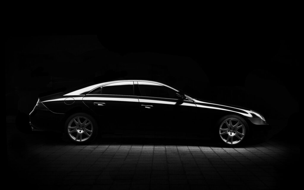 Black car subtly lit up against a black background.